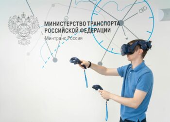 a man in a blue shirt using a pair of virtual glasses